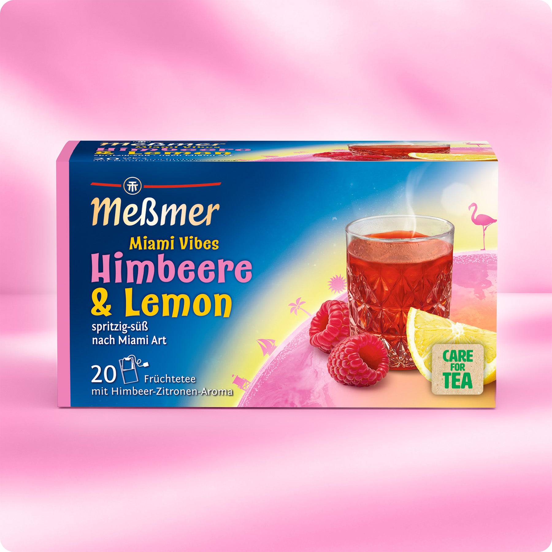 Verpackung von Meßmer Miami Vibes Früchtetee mit Himbeer-Zitronen-Aroma, zeigt ein Glas roten Tee, Himbeeren, Zitronenscheibe und Flamingo-Motiv auf rosa-blauem Hintergrund.