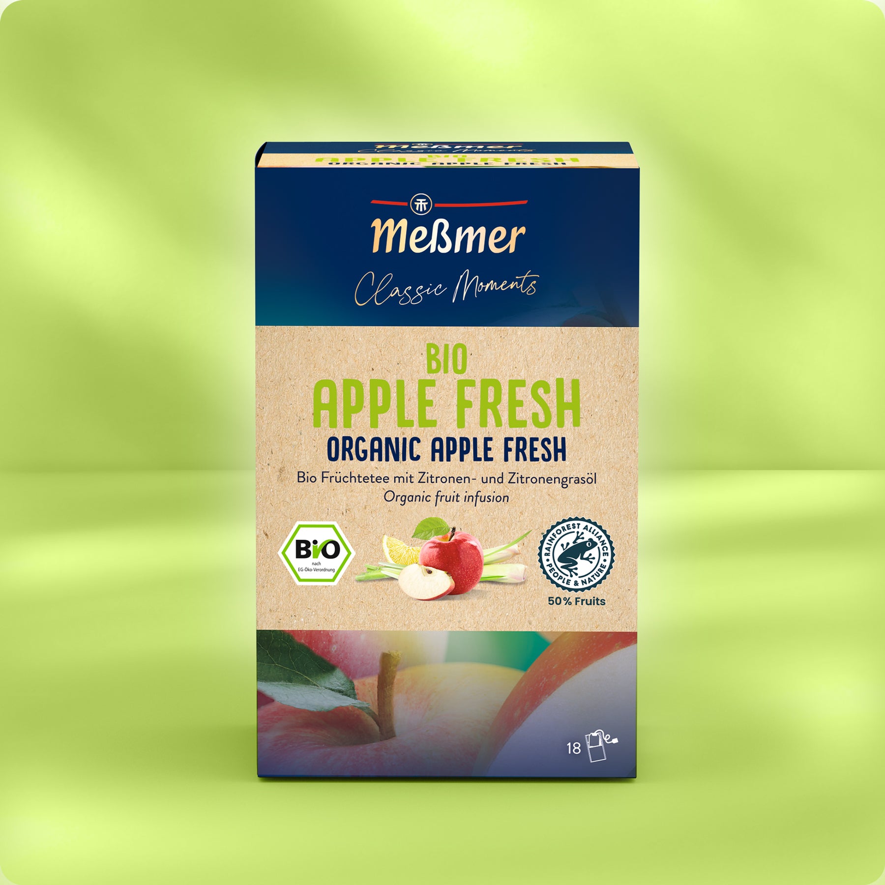 Meßmer DE Bio Apple Fresh Apfeltee mischt die Geschmacksrichtungen Apfel und Zitronengras. Die grüne Box enthält Äpfel, eine Zitronenscheibe, Teebeutel und verspricht ein einzigartiges Geschmackserlebnis.