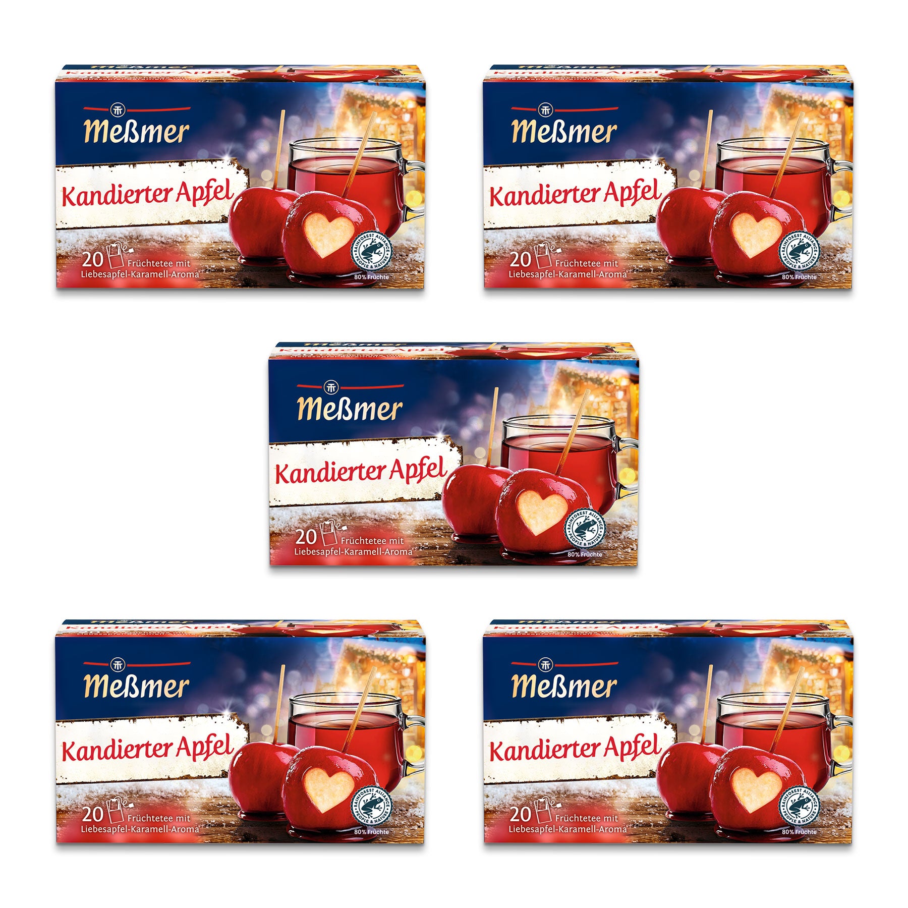 Abgebildet sind fünf Schachteln Meßmer Kandierter Apfel Tee. Jede Schachtel zeigt ein Glas roten Apfeltee, zwei rote kandierte Äpfel und enthält 20 Teebeutel. Auf einem Apfel ist ein Herz abgebildet.