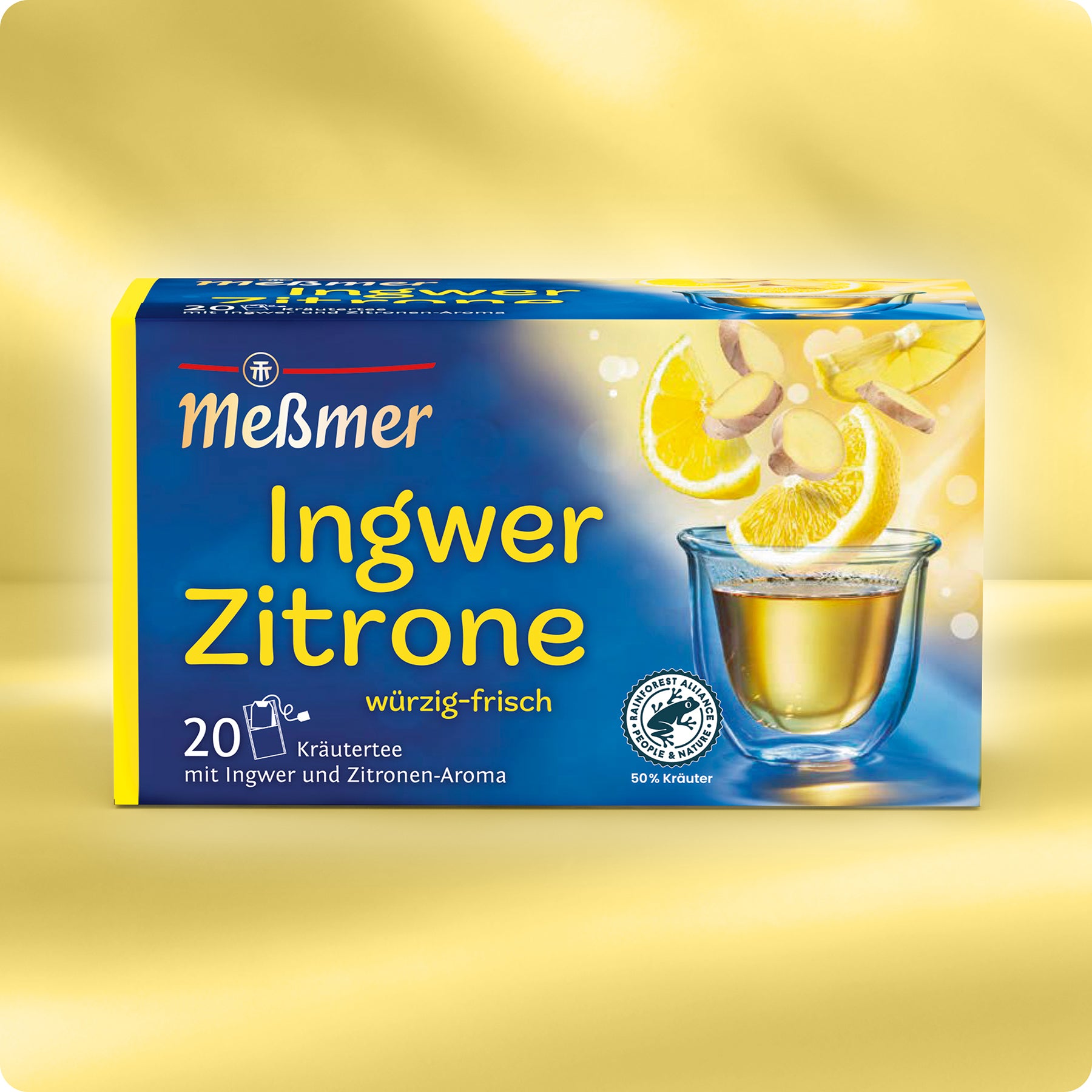 Eine Schachtel Meßmer DE Ingwer-Zitrone Tee, mit gelber und blauer Verpackung wie Mango Tee und Brennnessel Tee, zeigt auf der Vorderseite ein Glas Tee, Zitronenscheiben und Ingwer. Die Produktangaben sind auf Deutsch.