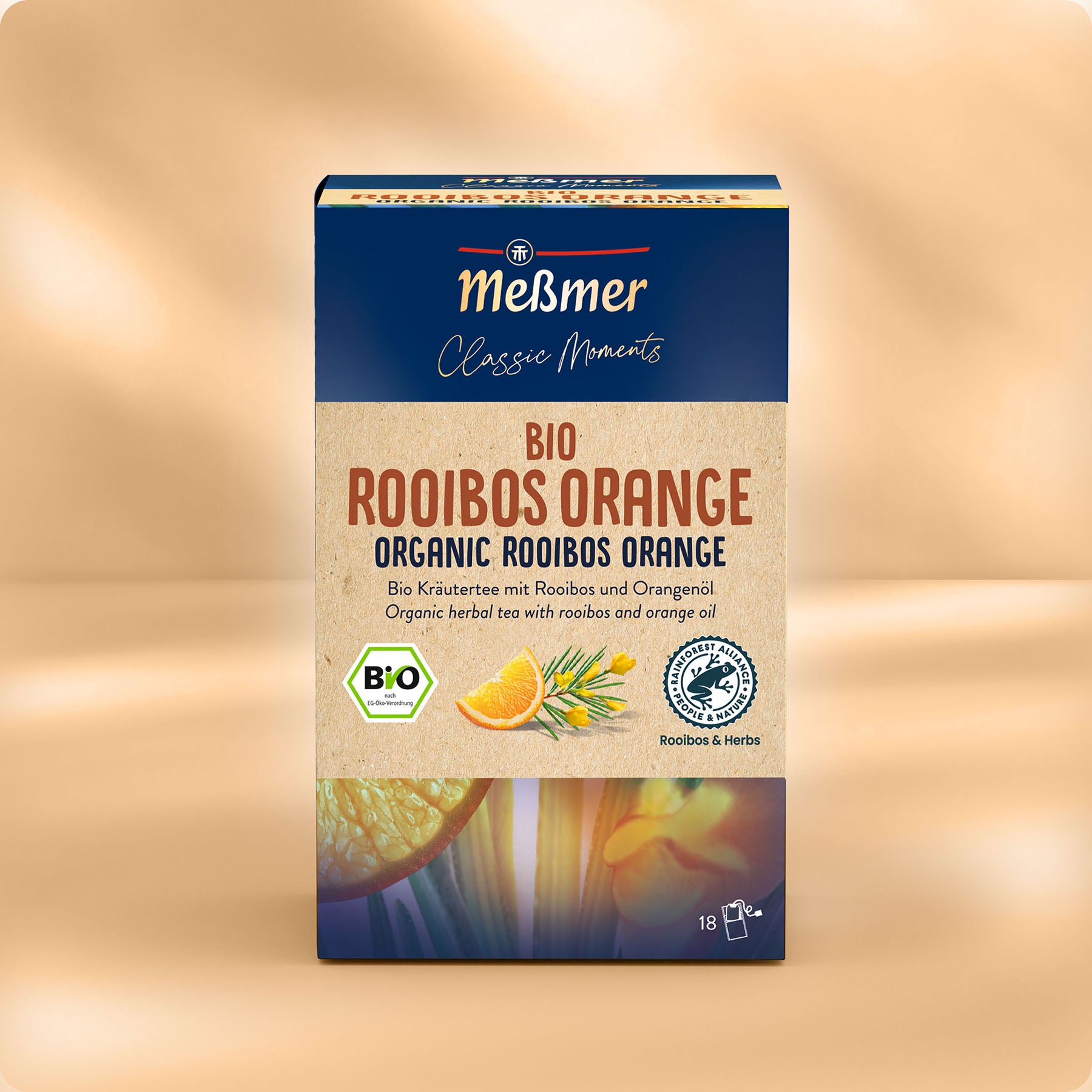 Eine Schachtel Meßmer DE Bio Rooibos Orange mit 18 Teebeuteln, mit Abbildungen von Orangenscheiben und Rooibosblättern auf beiger Verpackung in deutscher und englischer Sprache.
