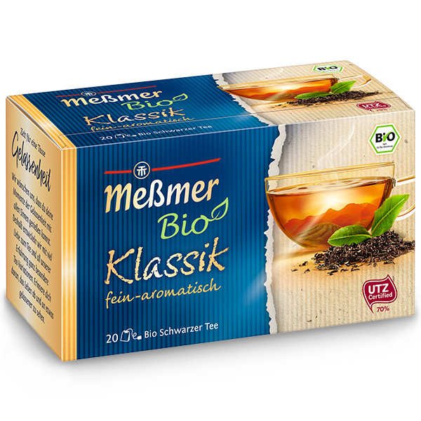 Teebox mit Bio Minze-Ingwer, zeigt eine Tasse schwarzen Tee mit Minzblättern, Verpackung in Blau und Beige mit Bio- und UTZ-Zertifizierung, aromatischer Tee genussvoll präsentiert.