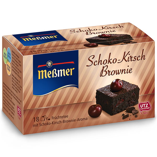 Verpackung mit Schoko-Kirsch-Brownie-Motiv, zwei Kirschen und Schokoladenstücken, daneben Himbeertörtchen als Geschenkidee oder Genussoption dargestellt.