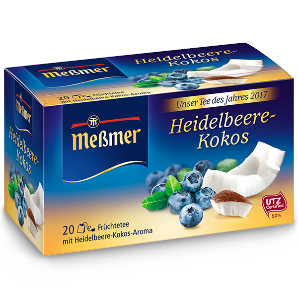 Verpackung des Moringa-Mate-Ingwer Tees mit fruchtigem Heidelbeer- und Kokos-Motiv in Blau- und Gelbtönen präsentiert.